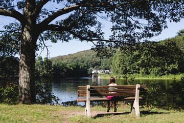 girl on bench near river