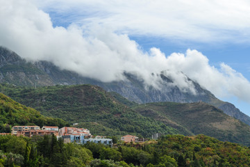 Fototapeta na wymiar Becici, Montenegro, View of the city and mountains. Mountains above the clouds