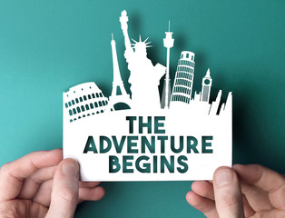 The adventure begins paper cut out shape with famous city travel destination landmarks