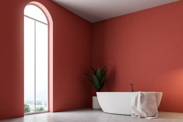 Minimalistic red bathroom corner, white bathtub