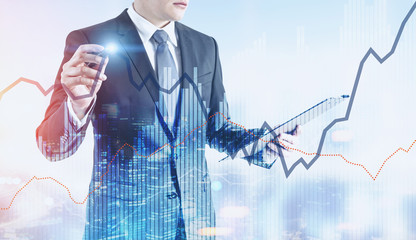 Businessman with a glowing pen, night city graphs