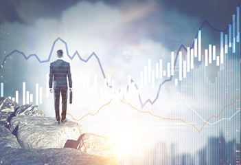 Businessman looking at graphs in the sky