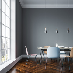Gray dining room interior, pastel chairs close up