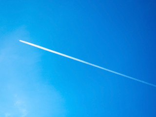 long contrail cloud of smoke from jet engine