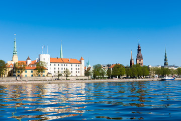 view of the spires of the cathedrals of Riga and Riga castle in the old town from river Daugava
