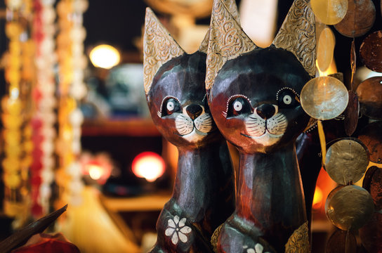 handcrafted oriental wooden carved cats in a bazaar market stall