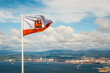 close up of Gibraltar flag waving against blue sky
