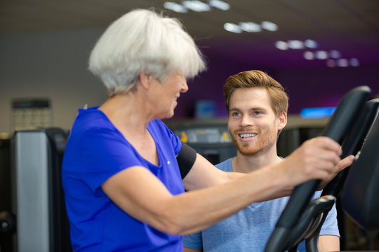 senior woman doing exercises with coach