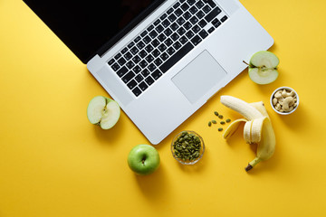 Overhead flatlay image with notebook and healthy snacks on colorful background. Modern lifestyle...