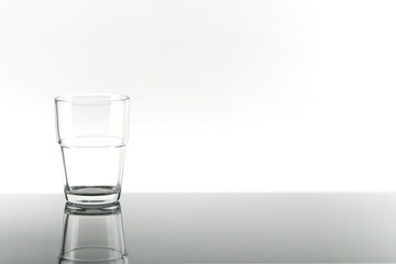 Empty Glass with Reflection of crystal glass from the table on white background. Concept of Nature, Healthy Lifestyle. Healthcare And Beauty, freshness.