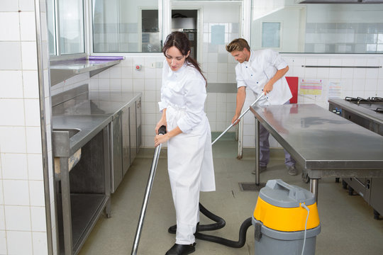 Workers cleaning kitchen floor