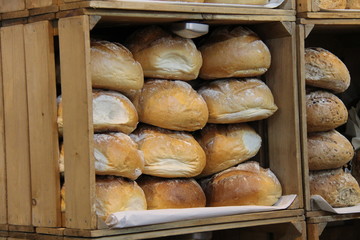Wooden Boxes Displaying Freshly Baked Bread Loaves.