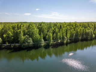 drone image. aerial view of rural area lake in forest with green water