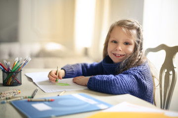 Smiling child drawing