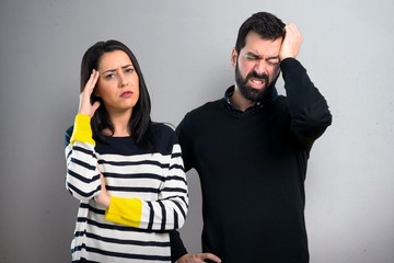 Frustrated couple on grey background