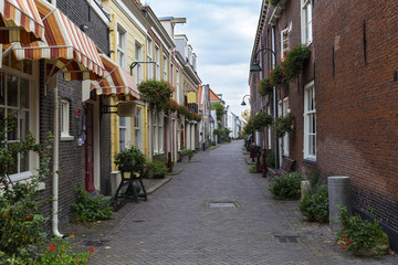 Fototapeta na wymiar Narrow colorful street of the medieval Delft, Holland.