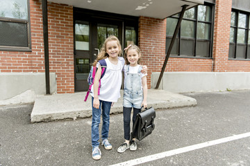 Two students outside at school standing together