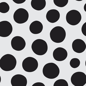 Seamless vector pattern of hand drawn polka dots, random spots in various sizes. Big and small dark circles in black and white. Stylish monochrome abstract background. Simple retro design elements.