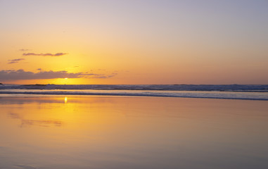 Fototapeta premium The beach in sunset time. Beautiful sky and reflex color on the beach. city of San Sebastian, Spain
