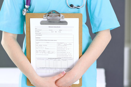 Female doctor holds medication history form while standing straight in hospital closeup. Healthcare, insurance and excellent service in medicine concept