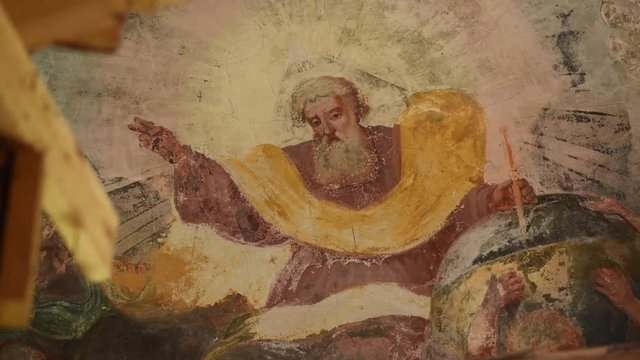 old shabby Christian painting on the base of the dome