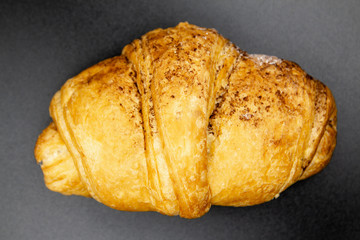 croissant on a dark blue background. french food 