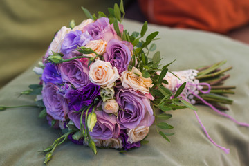 wedding bouquet on a green cushion, bouquet of bride from rose cream spray, rose bush, rose purple Memory Lane, violet eustoma, eucalyptus