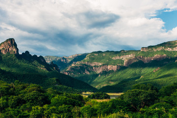 Fototapeta premium the beauty of nature, mountains covered with lush vegetation, under a sky of white clouds