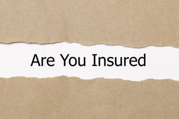 Fototapeta na wymiar are you insured written under torn paper. Insurance concept