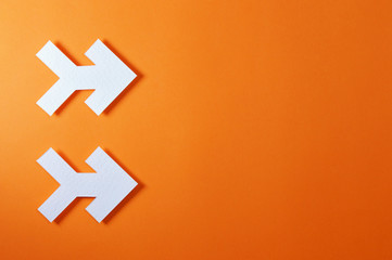 Fototapeta premium two arrows on orange background