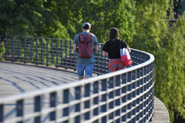 Fototapeta na wymiar A young couple is walking on a bridge in the government district of Berlin-Germany