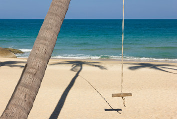Obraz na płótnie Canvas Swing hanging from palm tree on the beach in the island of Koh Phangan, Thailand. Summer vacation, travel holidays destination, leisure time concept