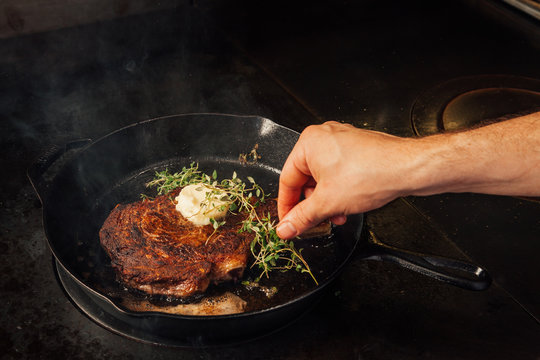 Cooking Steak In A Cast Iron Pan.