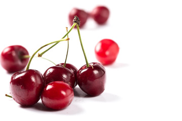 Ripe red cherry on a white background.