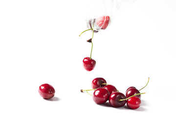 Ripe red cherry on a white background.