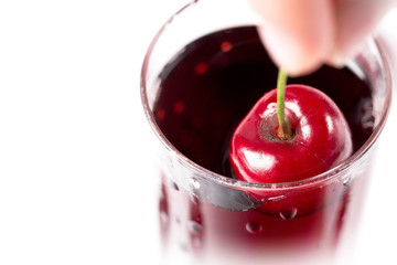 Cherry in a glass with juice, close-up