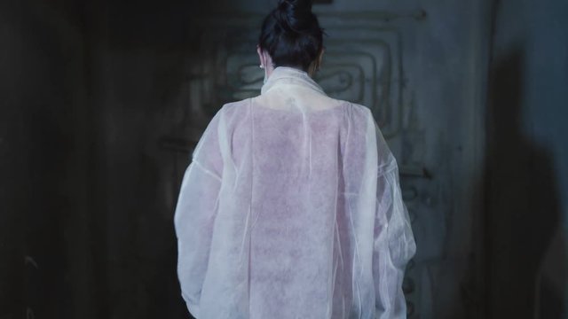 Woman go in dark underground bunker