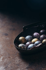 pile of different chocolate candies in metal basket on table