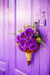 The violet Gerbera bouquet hanging on the master key to lock the violet wooden door in any house of...