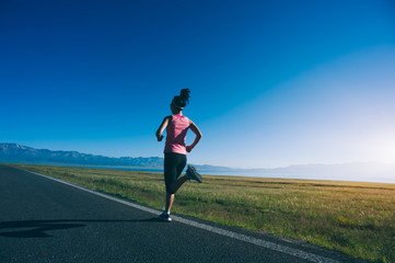 Fototapeta na wymiar Young fitness sporty woman running on country road