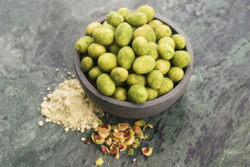 Pile of wasabi coated peanuts in bowl