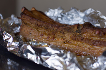 Baked meat in foil. Breast fried in the oven. Bacon with spices