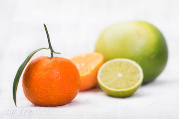 Refreshing citrus fruits on a white tablecloth