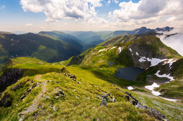 beautiful landscape of Romanian mountains. lovely summer scenery on a cloudy day. Lake Capra down the hillside