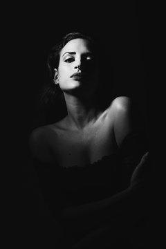 Young Brunette Woman In Black Lingerie In Chiaroscuro Lighting