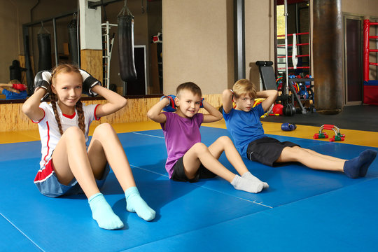 Cute little children doing exercises in gym