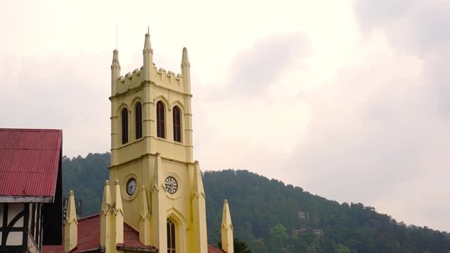 Christ church on shimla ridge during a cloudy evening, the beautiful orange sky and birds flying on the building highlight the beauty of this landmark. It is a very famous tourist destination