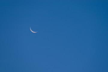Moon crescent over blue sky  