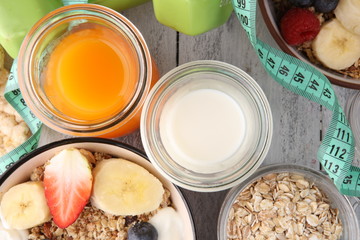 muesli with dairy and fruit, healthy lifestyle. bowl of cereal, fruit and dumbbell
