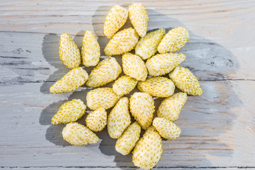 White wild strawberries on a wooden table natural background